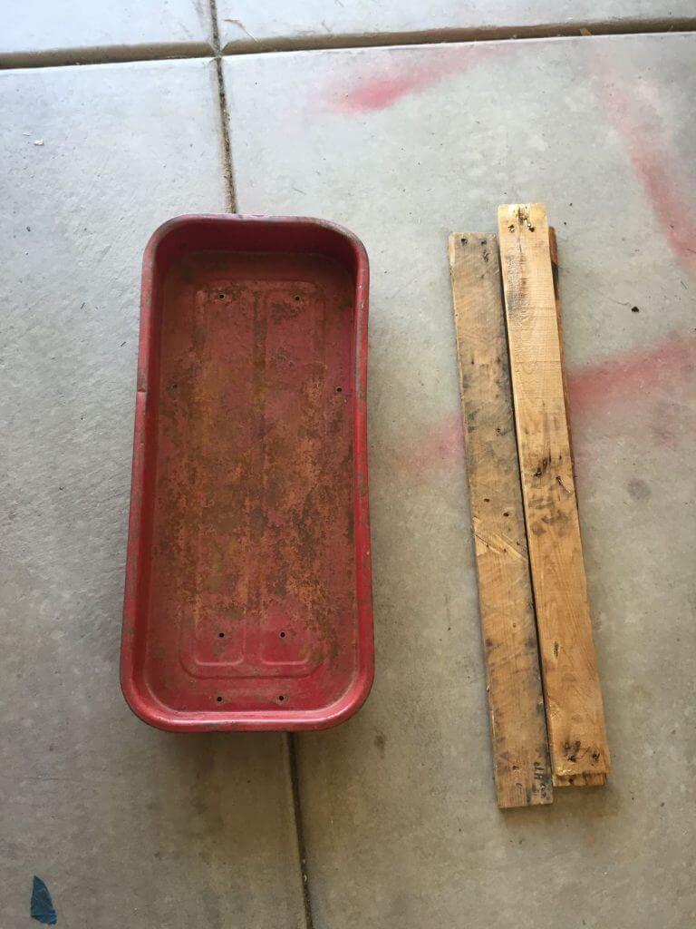 wagon next to two pieces of wood all dirty