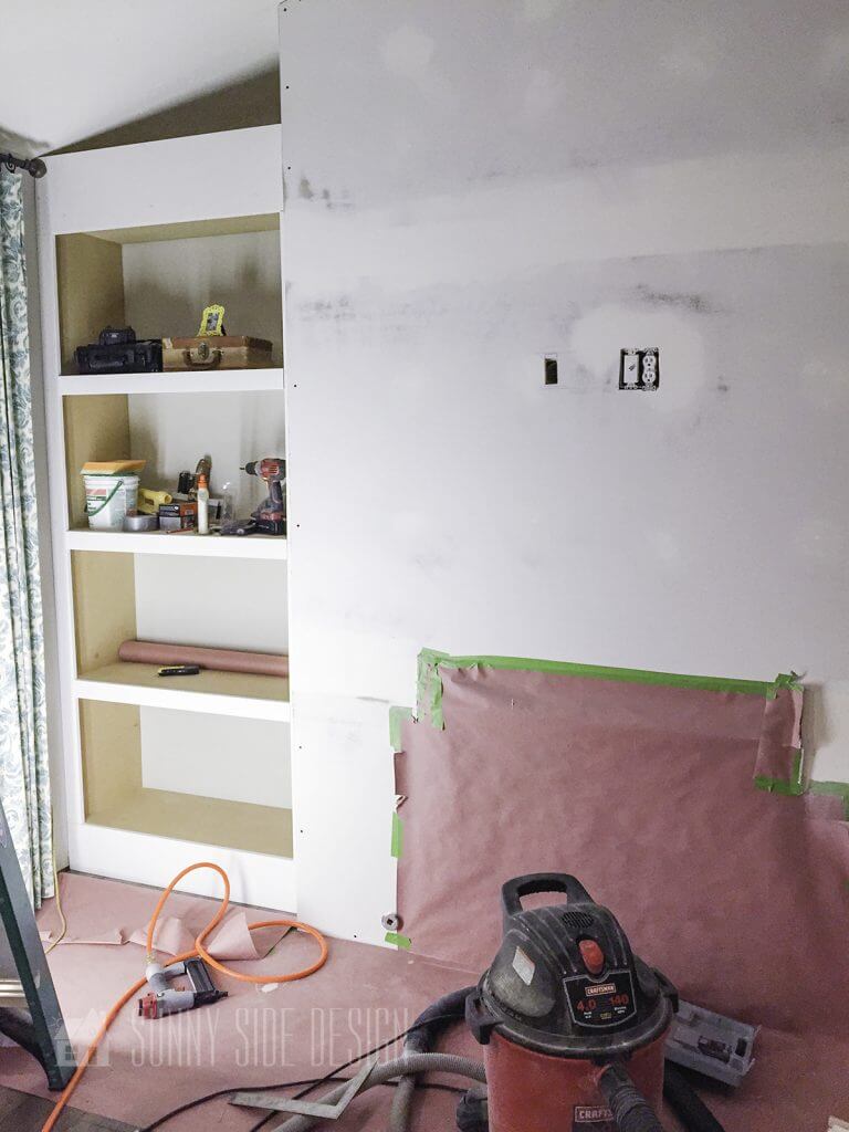 taping over fireplace with drywall and mud on