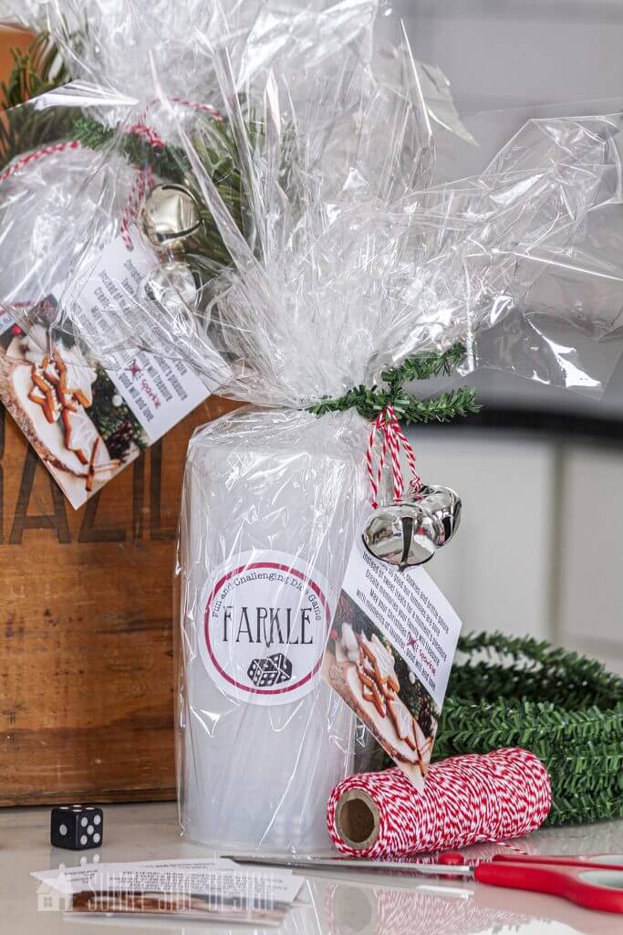 wrapped cheap neighbor gifts with wired greenery is used to tie the package closed, embellished with small bells