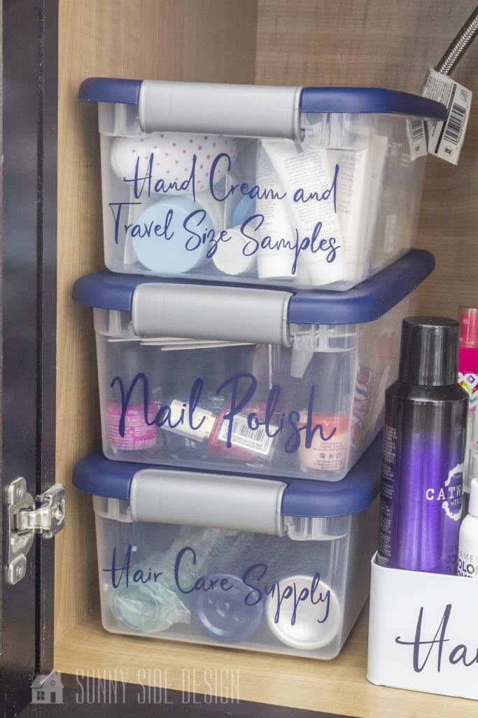 Cabinet is organized with labeled clear plastic storage boxes.