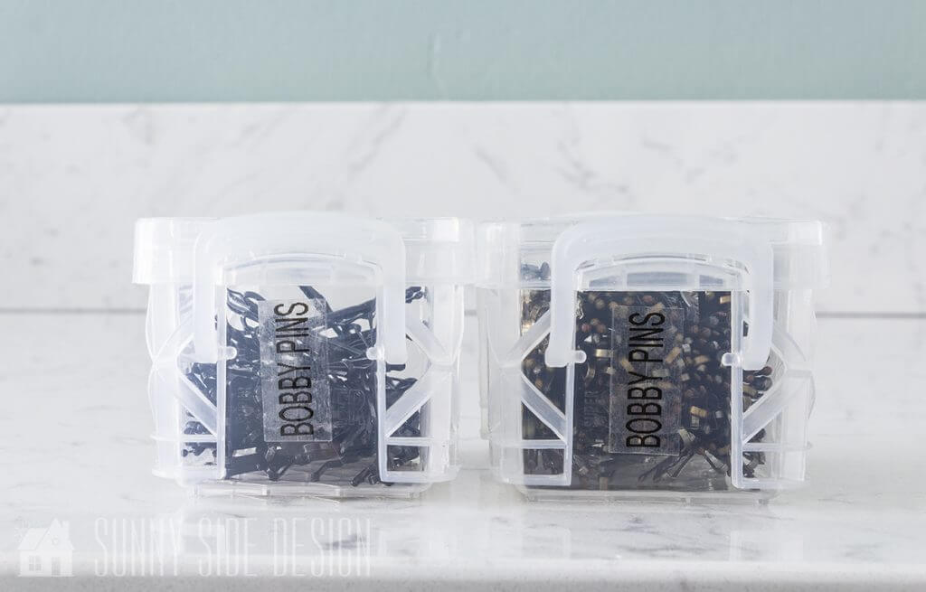 Small covered plastic containers are used to store bobby pins.