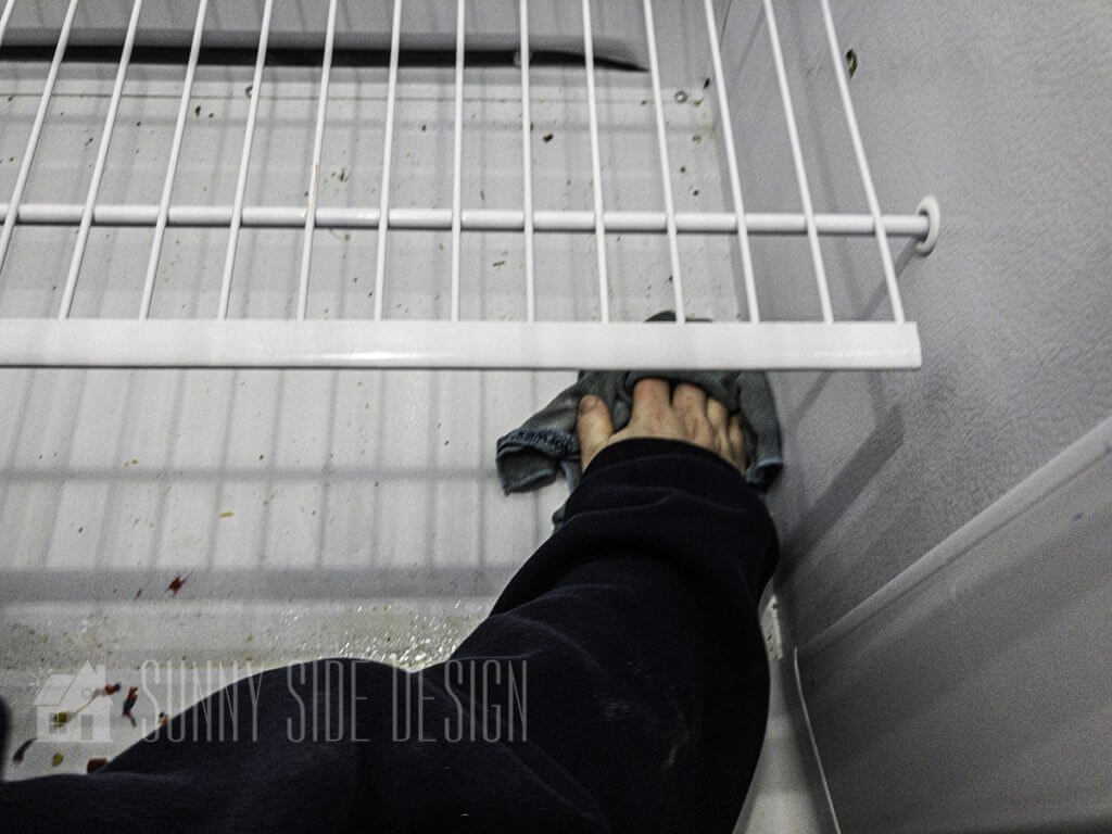 Wiping up spills in the deep freezer.