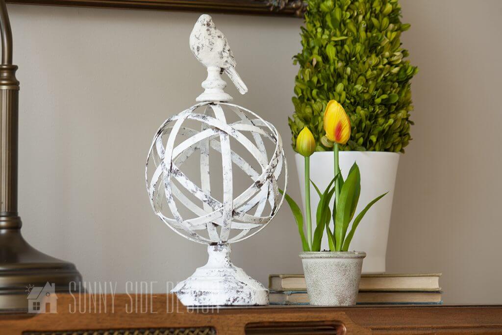 Spring decorating ideas, potted yellow tulips with green plant and bird decor.