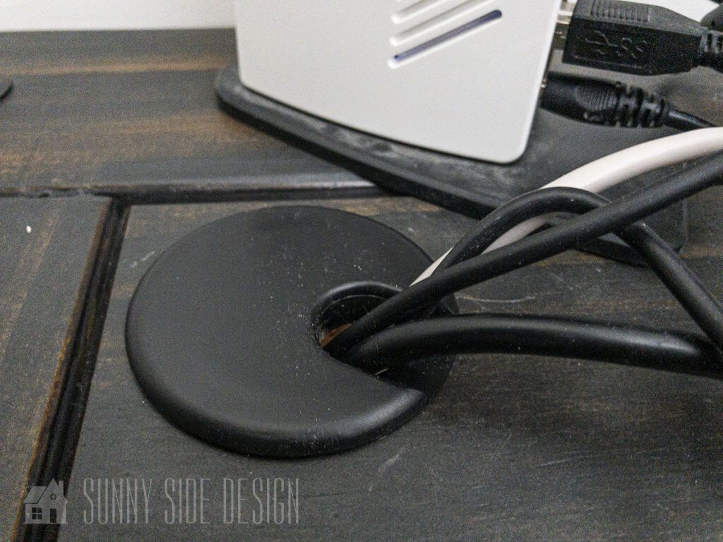 desk cords are neatly organized and threaded through a cable guide in the desk top.