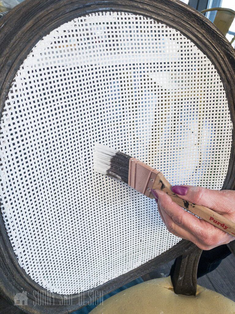 painting the cane on the bar stool backs to give it a fresh new look
