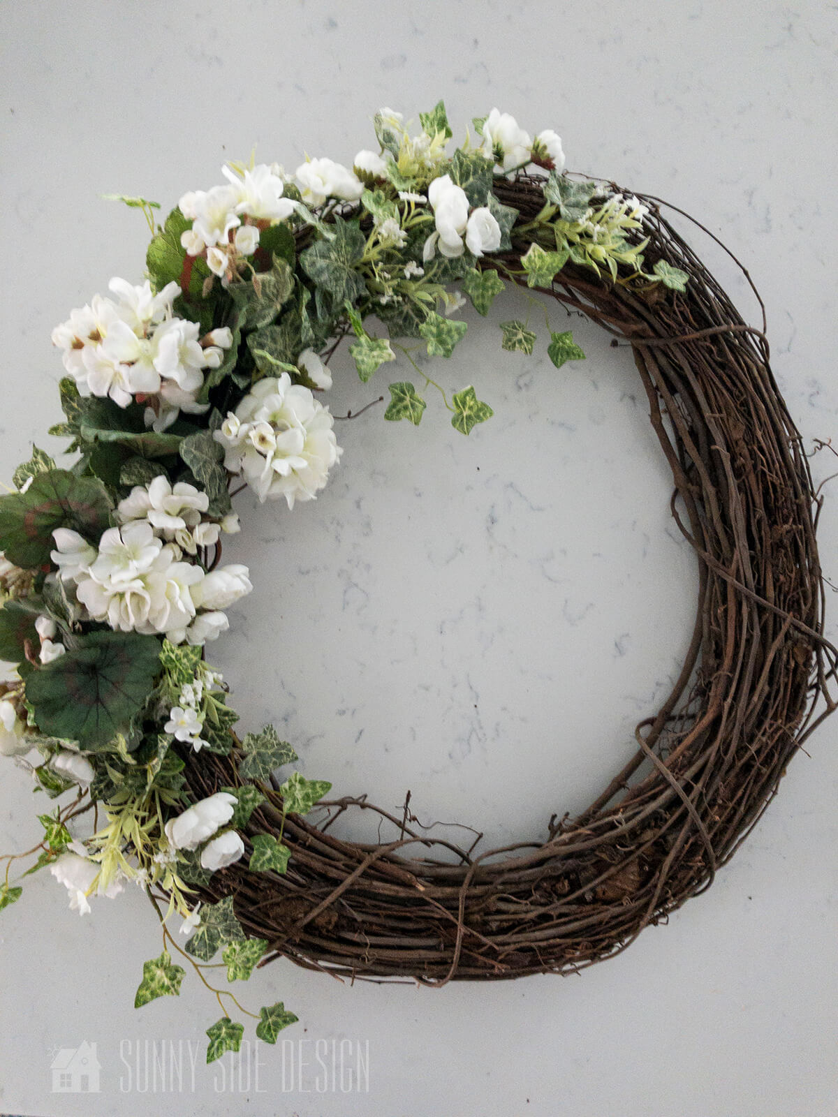 White floral and greenery front door wreath for summer.