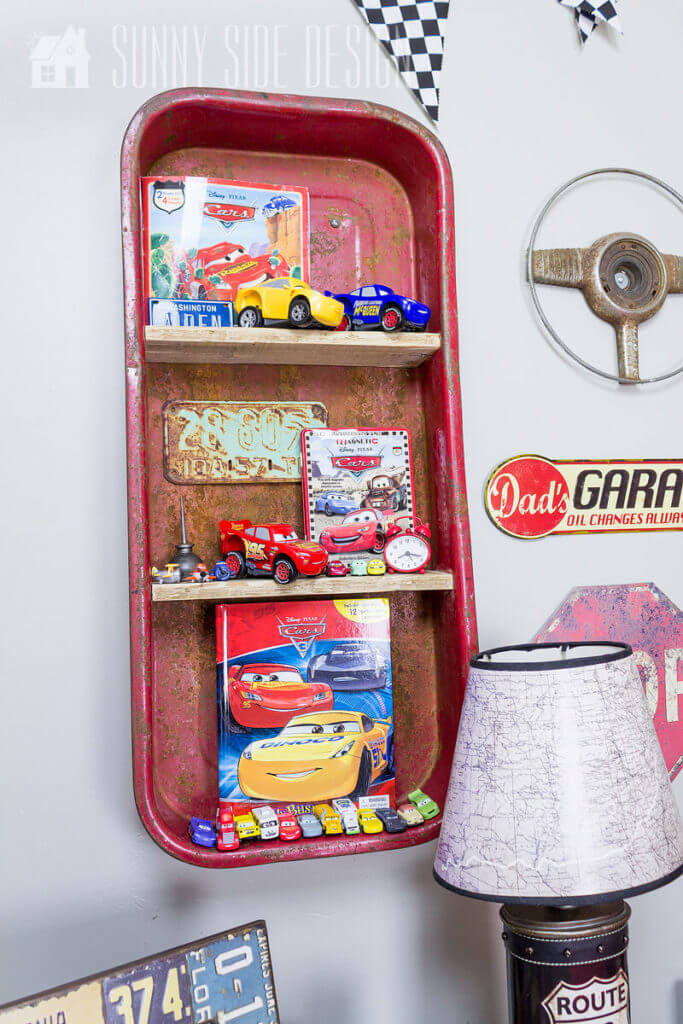 Flea market flip ideas, old wagon is upcycled into a wall shelf. toy card and books on the shelves.