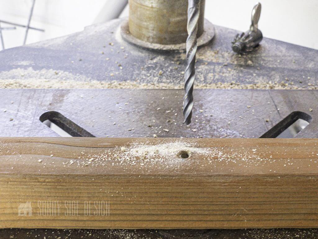 A drill is used to pre-drill holes for the trellis boards.