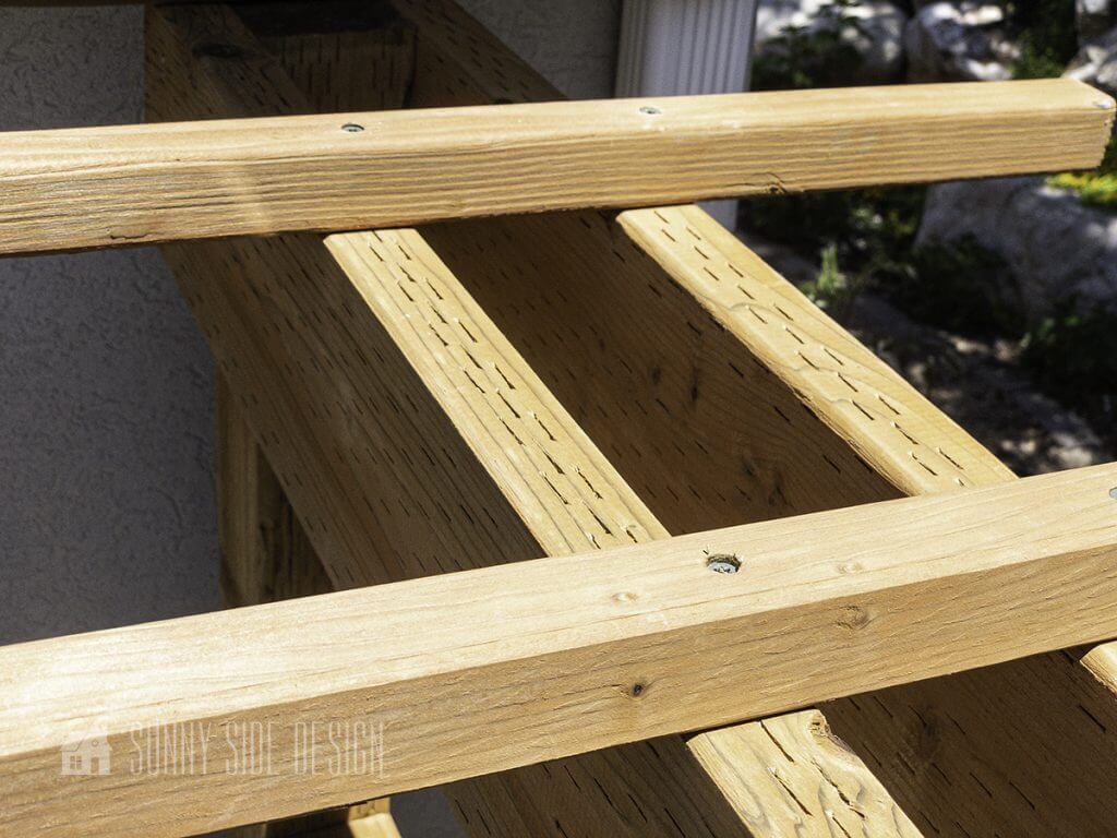 Trellis boards are secured to the top of the deer fence.