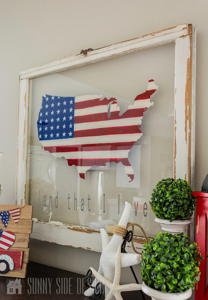 Vintage window with a flag painted in the shape of the United States.