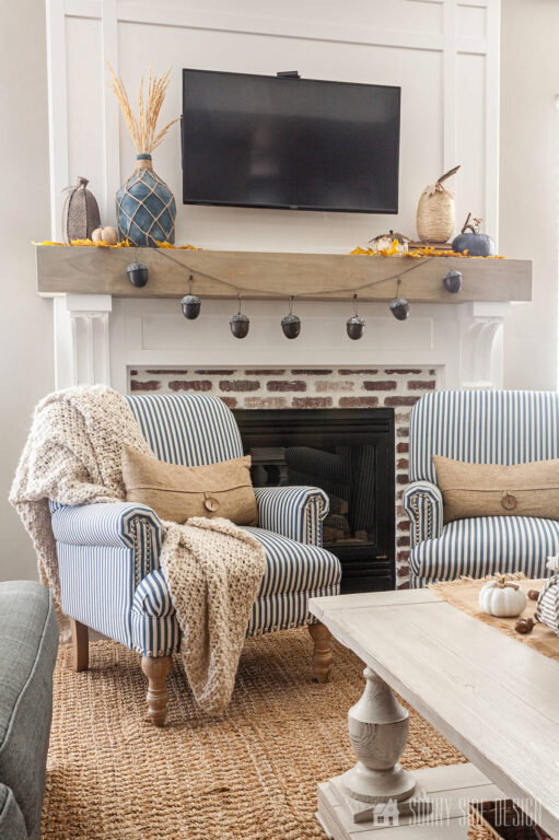 Easy fall decorating ideas, simple acorn garland at the mantle with pumpkins and fall leaves.