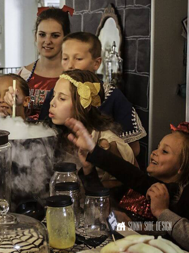 A magical Halloween Party Ideas is to include a witches brew. Kids around the cauldron in costumes.