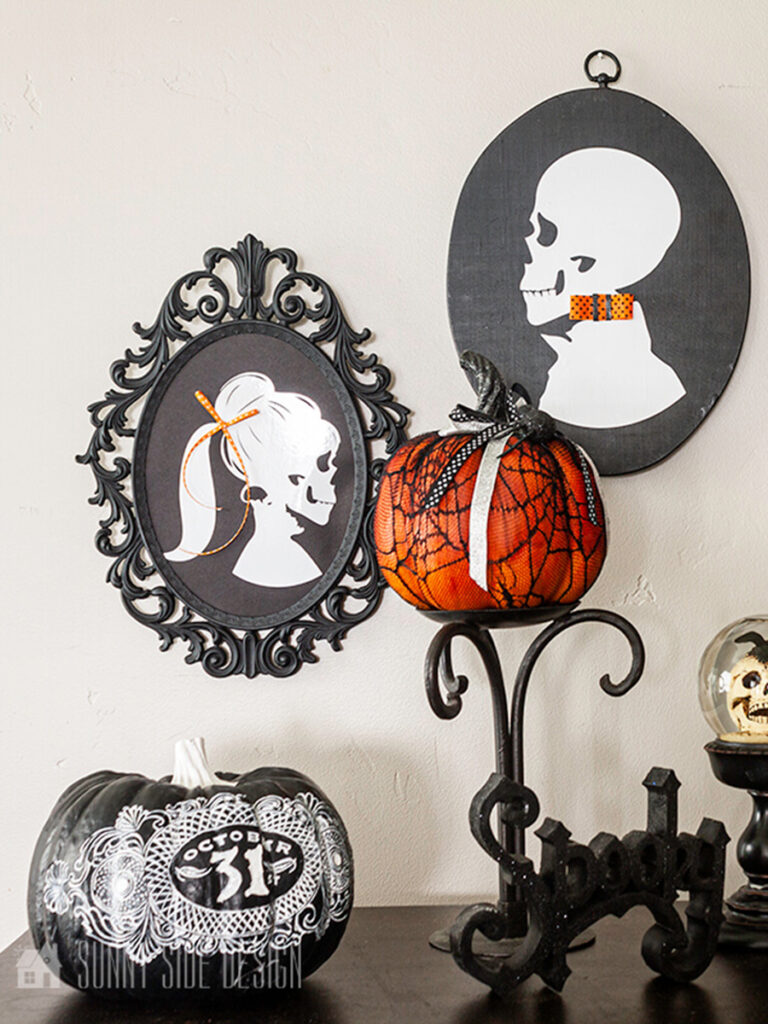DIY Halloween skeleton silhouettes in thrift store frames painted black, staged with pumpkins.