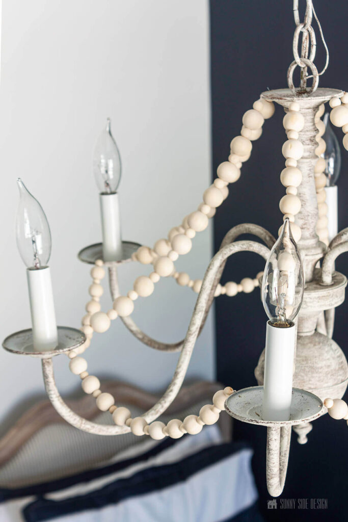 Updated old brass chandelier wit paint and wood beads give this dated piece a Boho, French country feel