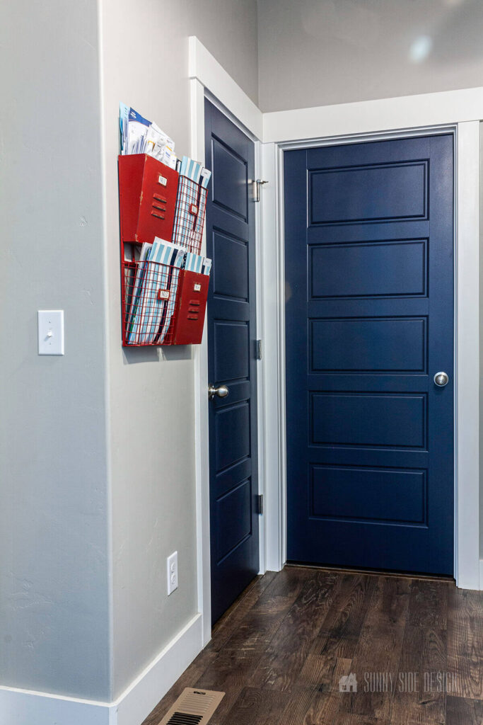 Interior doors painted navy blue, with gray walls and white moulding.