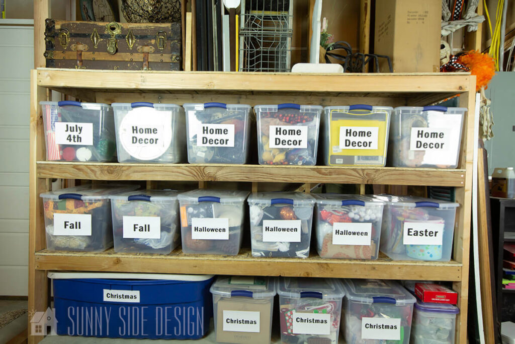 DIY custom shelves in the basement for seasonal and holiday storage. Clear labeled bins on shelves.