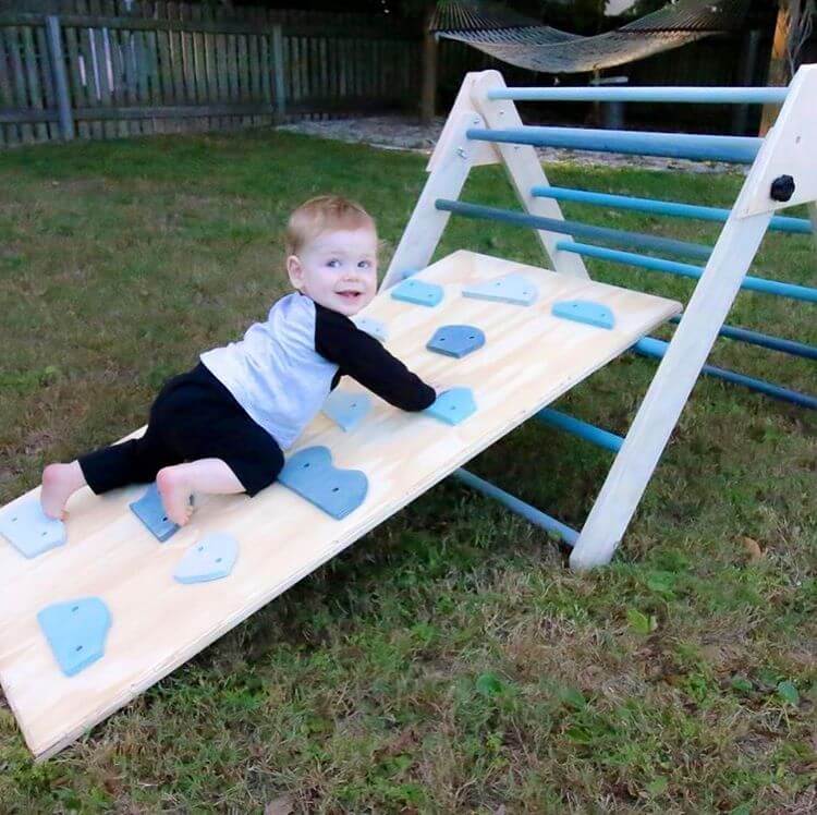 If you are a wood worker this would be so fun to build for a toddler. A  Pikler Triangle, baby boy is crawling up the play gym.