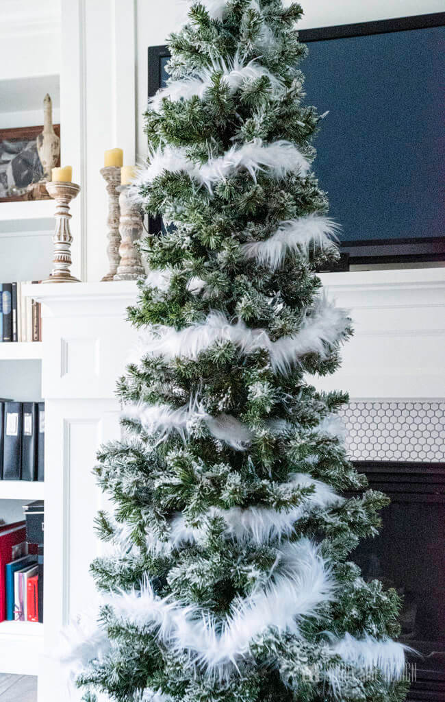 CHRISTMAS TREE DECORATING, faux fur placed around the Christmas tree.