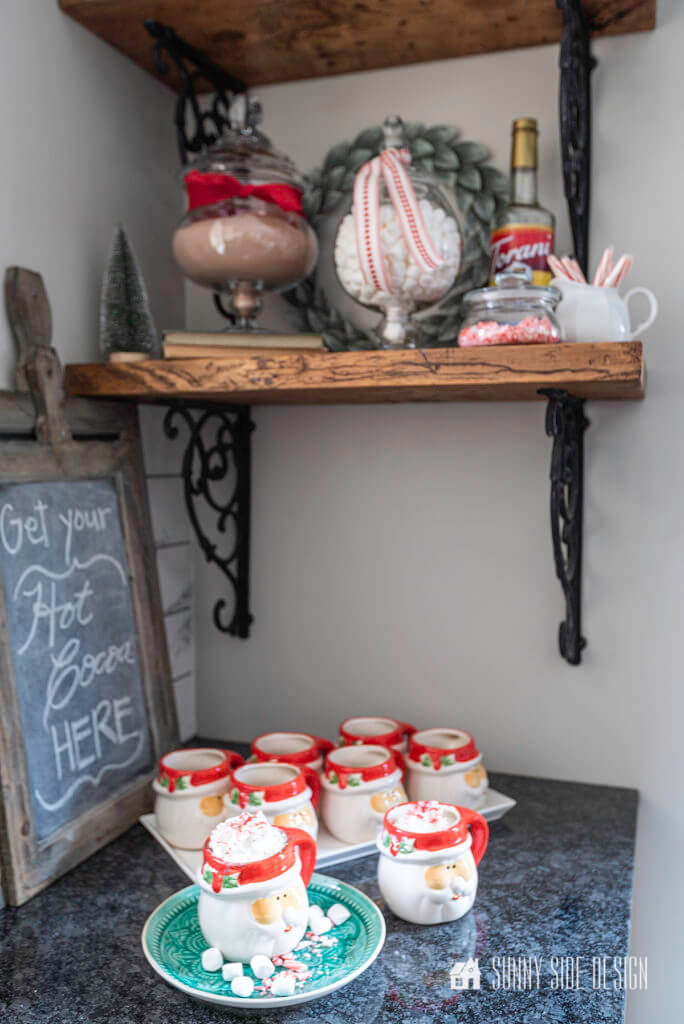 Christmas Decorating Ideas, hot cocoa bar with a collection of mugs and a chalkboard sign.