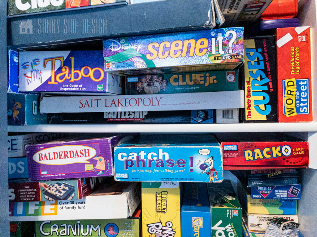 Game closet is stuffed with all shapes and sizes of game boxes. 