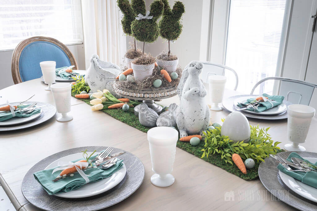 DIY Easter Table Decor Ideas, moss mat table runner with eggs, carrots and bunnies.