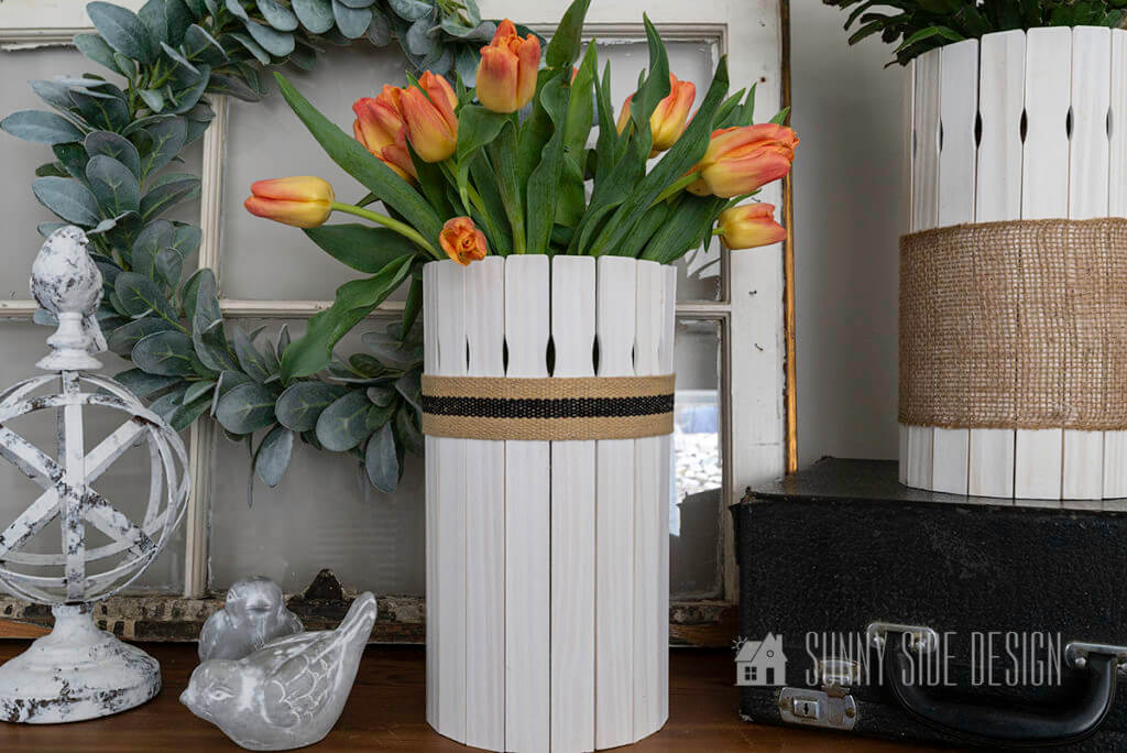 DIY wooden plant pot filled with tulips, styled with a lambs ear wreath, cement birds
