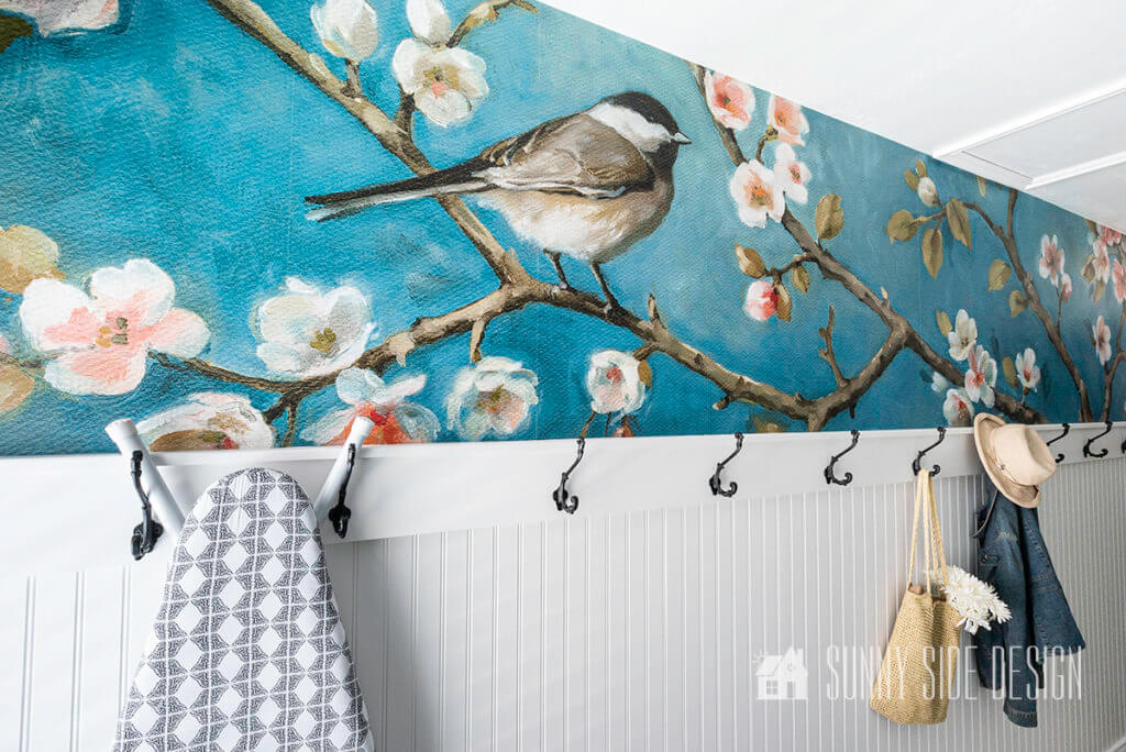 Finish cherry blossom wallpaper accent wall with a beadboard coat rack in the laundry room.