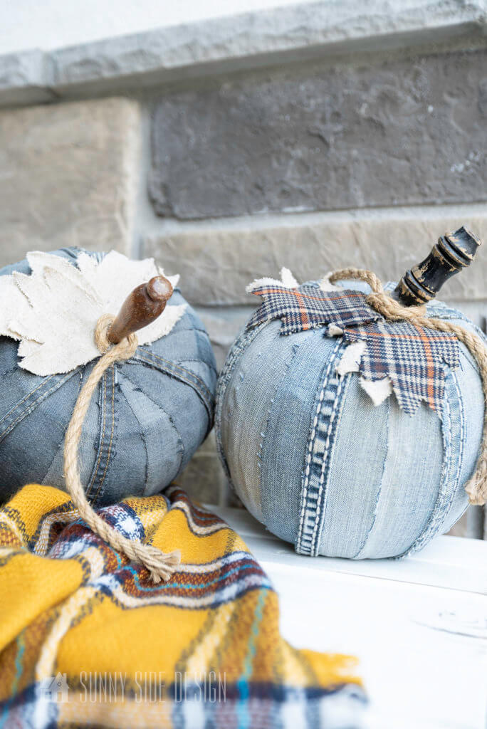 FallDIY Decorating Ideas with denim pumpkins placed on wooden bench with a mustard yellow plaid throw blanket decorate the front porch.