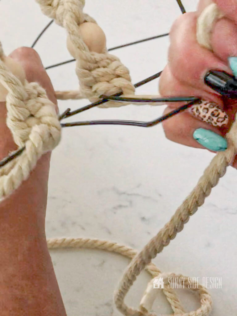 womens hand tying macrame knot