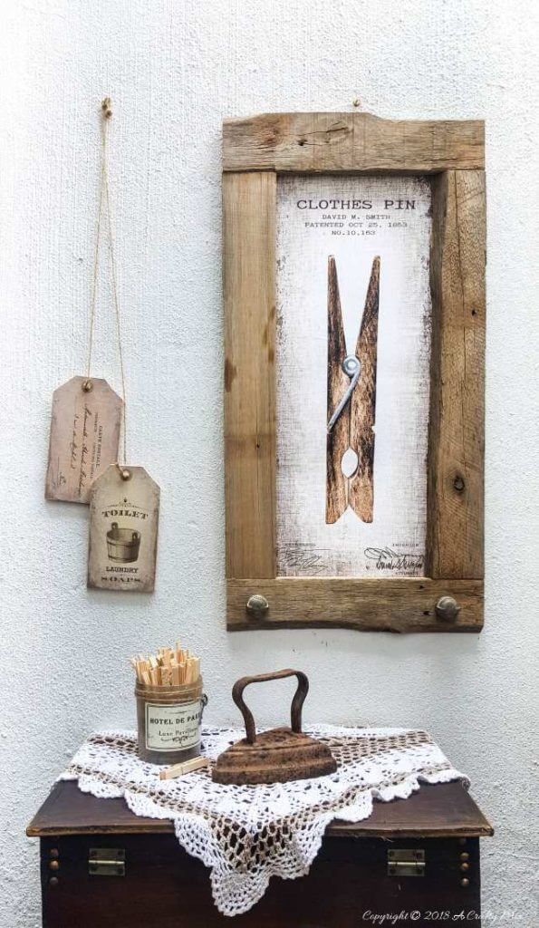 Laundry room ideas for decor. Framed clothes pin on wall. Antique iron on table with vintage clothes pins.