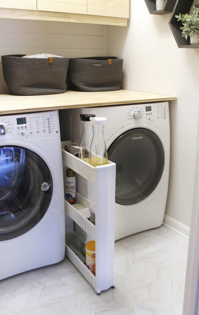 Laundry room idea for storage between washing maching & dryer. Small rolling cart fits inbetween appliances. 2 bins on top of folding table.