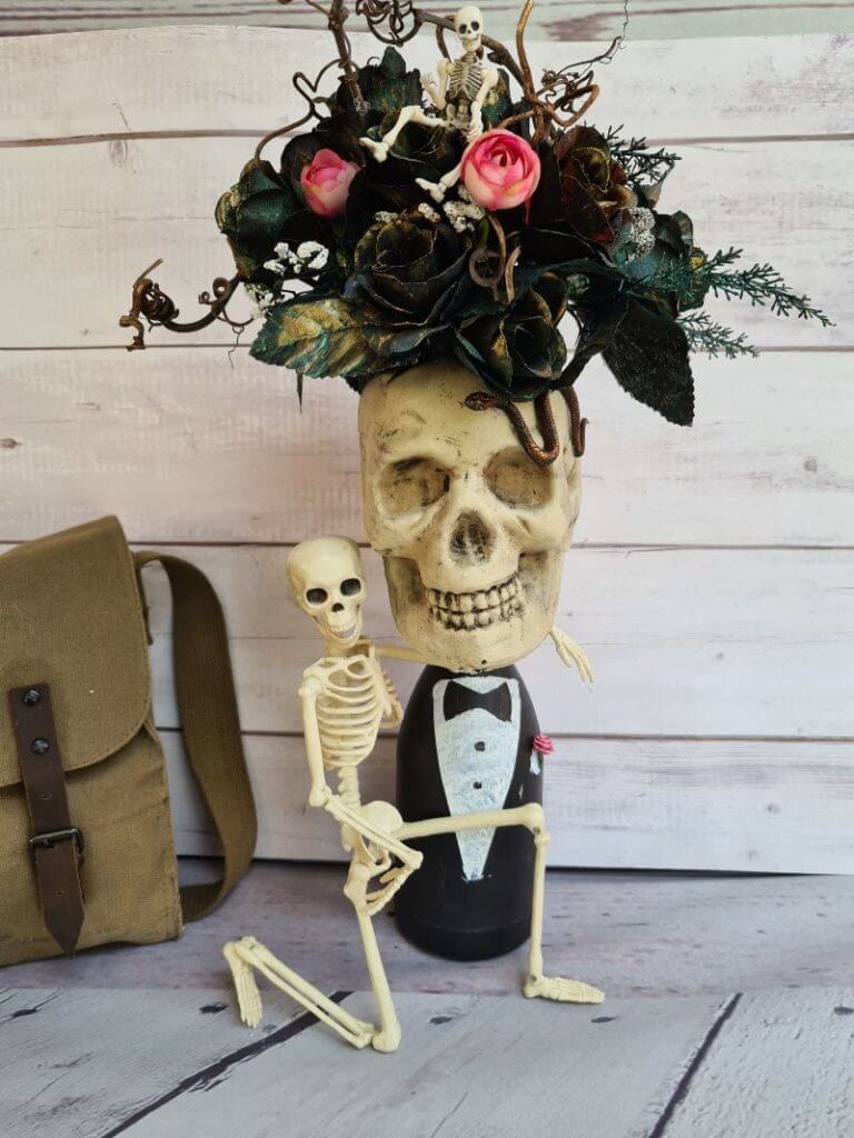 DIY Skull and skeleton vase with spooky Halloween flowers.