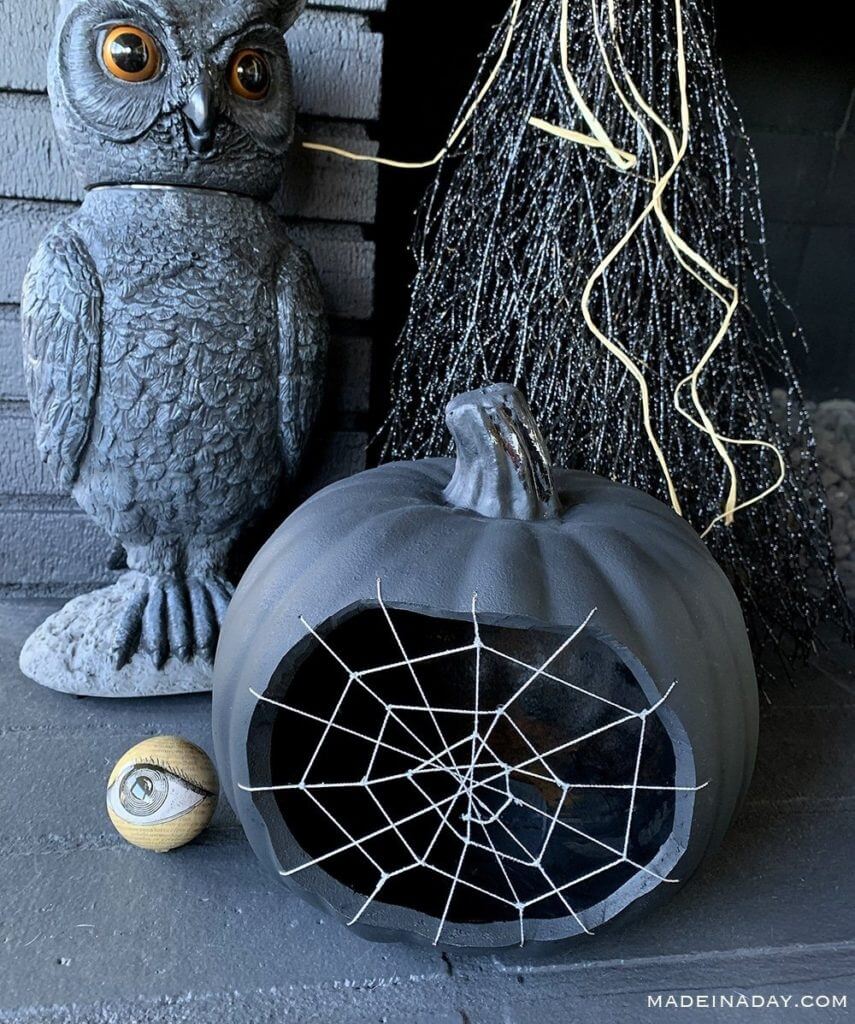 DIY Halloween decorations, spiderweb pumpkin decor, black owl, witches broom and painted eyeball.