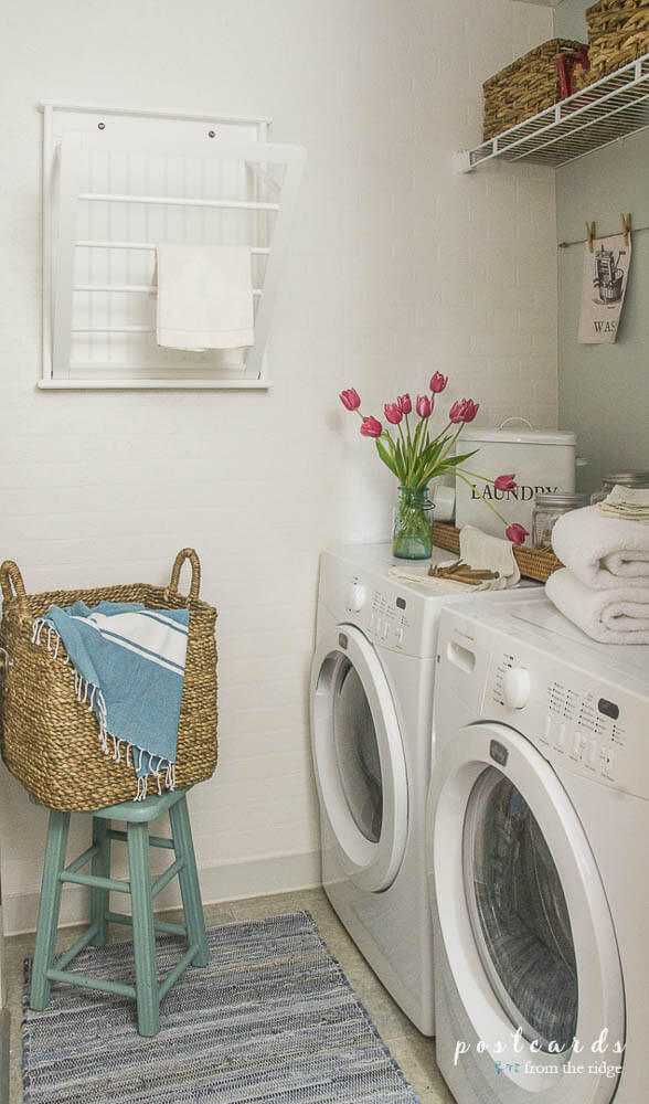 Small Laundry room idea, pull out drying rack, and white painted walls to make it feel light and airy.