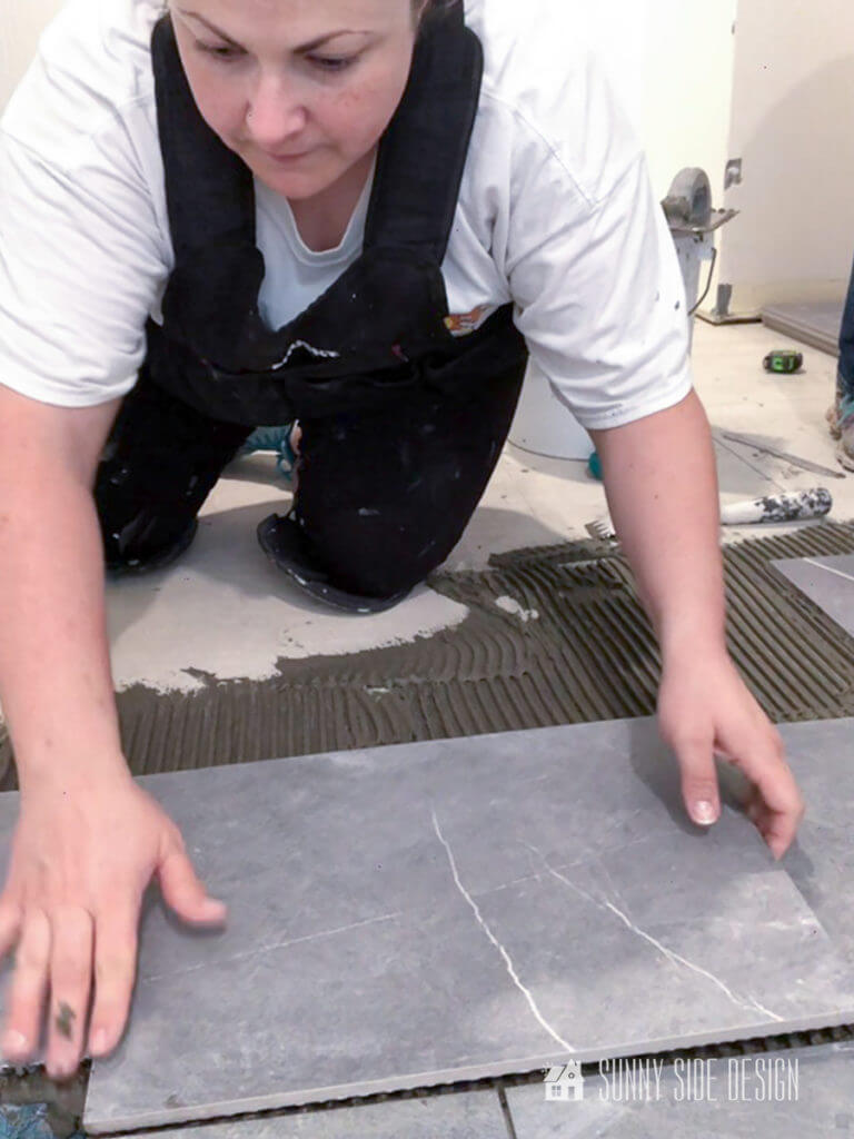 Woman installing grey Mable tile