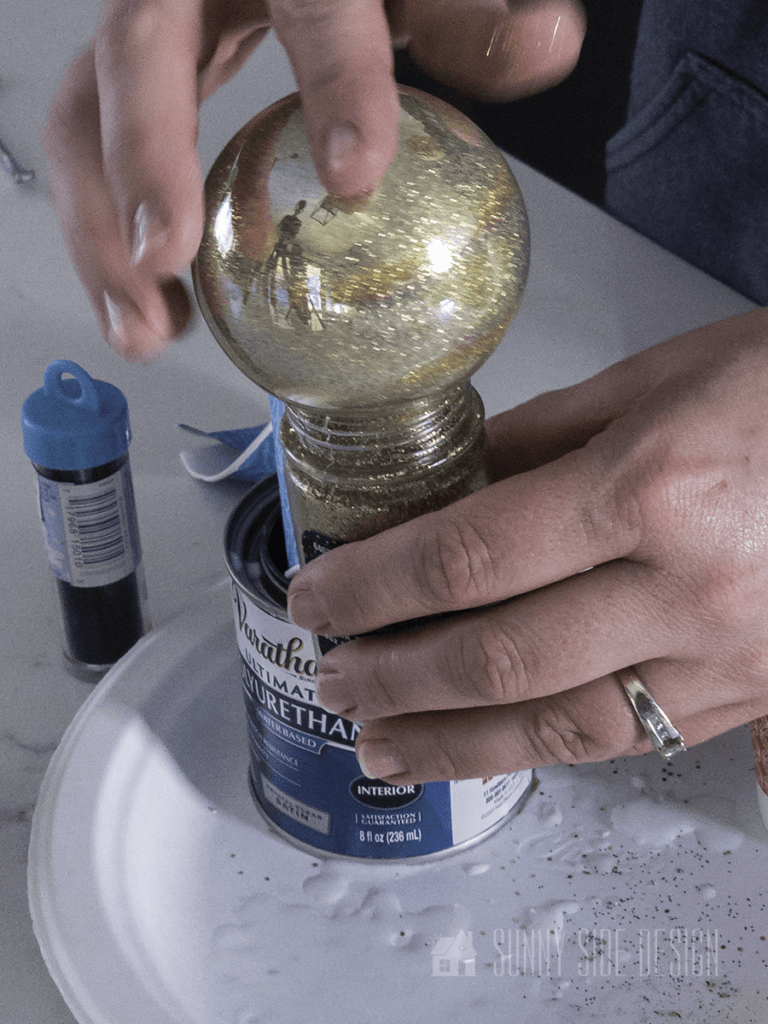 Pour excess glitter back into container.