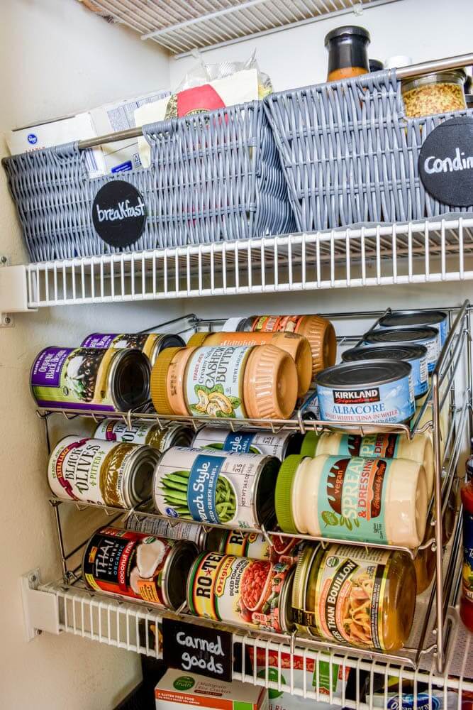 Pantry Organization Ideas - White wire pantry shelves are organized with basket for breakfast foods, condiments and rolling storage for canned goods.