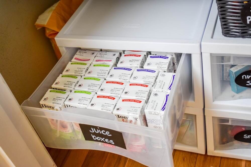 Pantry organization ideas - Lunch packing zone created with plastic storage drawer organizer, labeled with chalkboard labels. juice boxes, snacks etc.