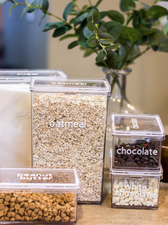 Pantry Organization Ideas - Clear rectangle containers labeled with white vinyl lettering for baking suppies.