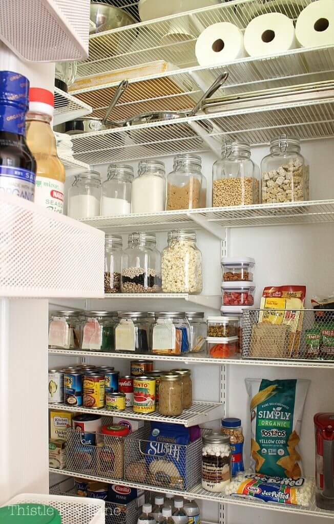 Pantry Organization Ideas - adjustable white wire shelves in pantry. Glass jars are used to store dry goods. Mesh boxes are used to organize packaged food.