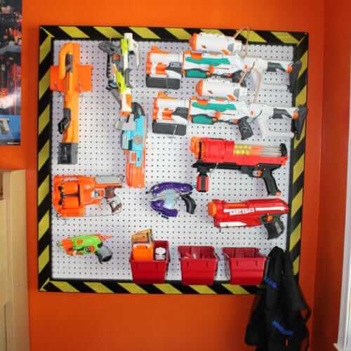 Toy organizing idea, nerf guns and supplies are stored on a peg board.