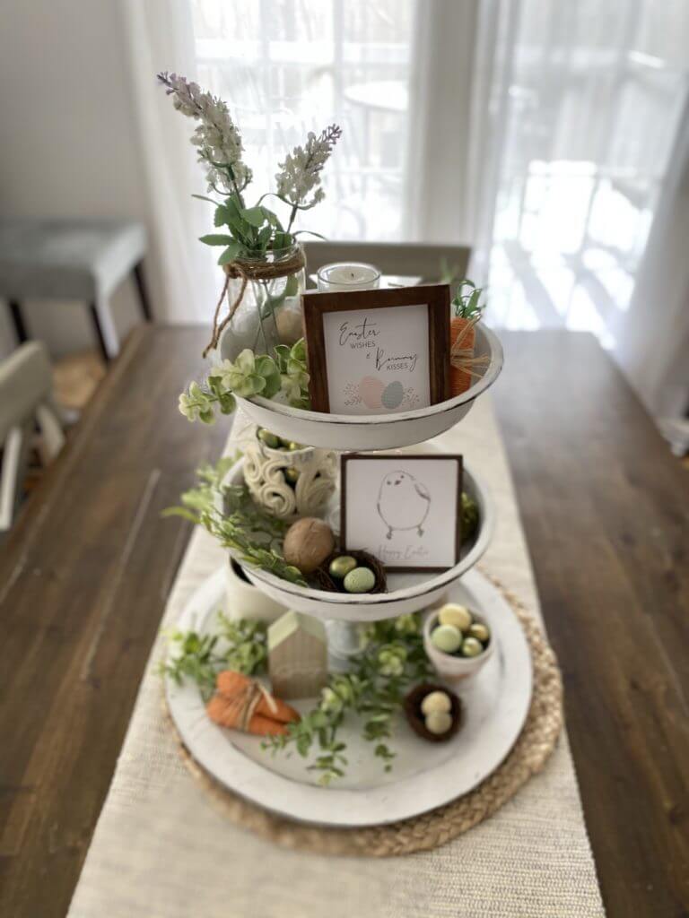 Easter Tablescape ideas, farmhouse style tiered tray centerpiece with greenery, eggs, carrots, and small signs.
