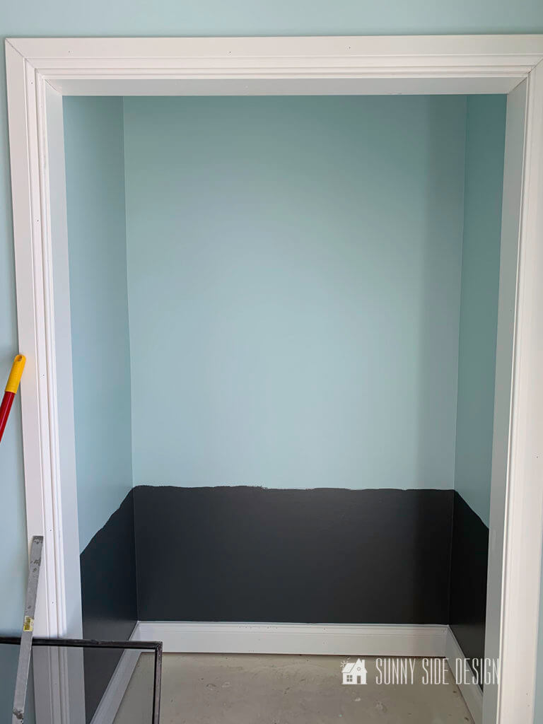 The lower portion of the cloffice area is painted charcoal grey and the upper portion is painted light blue.