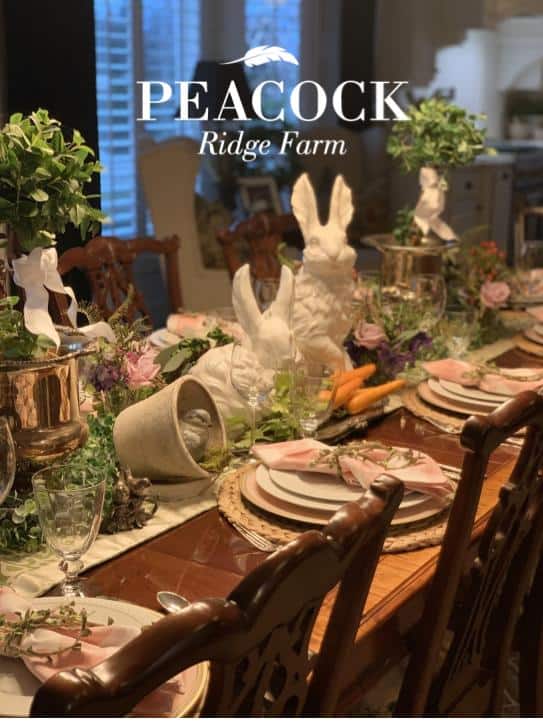 Easter Tablescape ideas, full table centpiece running the full length of the tale. green topiaries, bunnies, clay pots, birds, carrots and flowers.