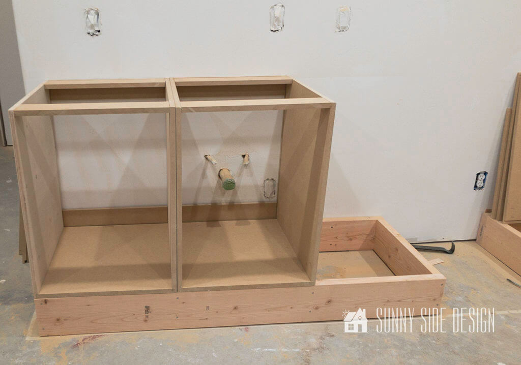 Two build cabinets are placed on the toe kick base for the kitchenette.