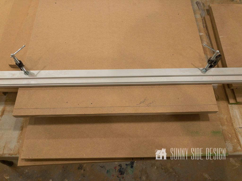 Make a cabinet, metal straight edge is clamped to the bottom panel of cabinet to cut a groove in board.