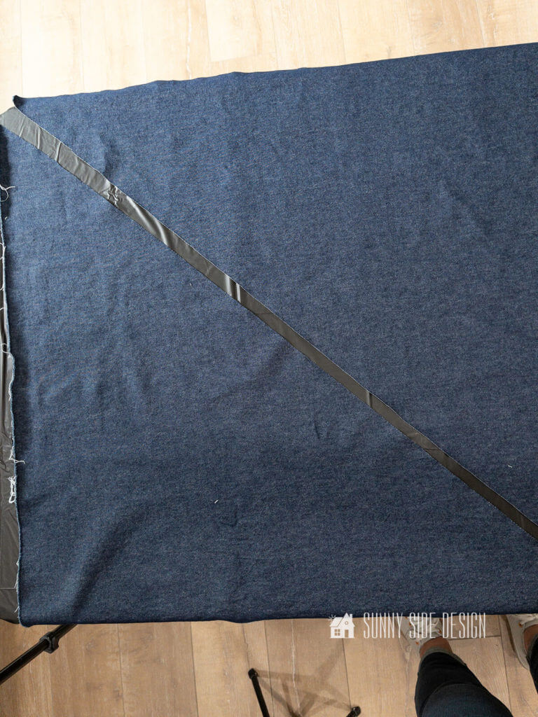 Two pieces of demin fabric cut on a diagonal.
