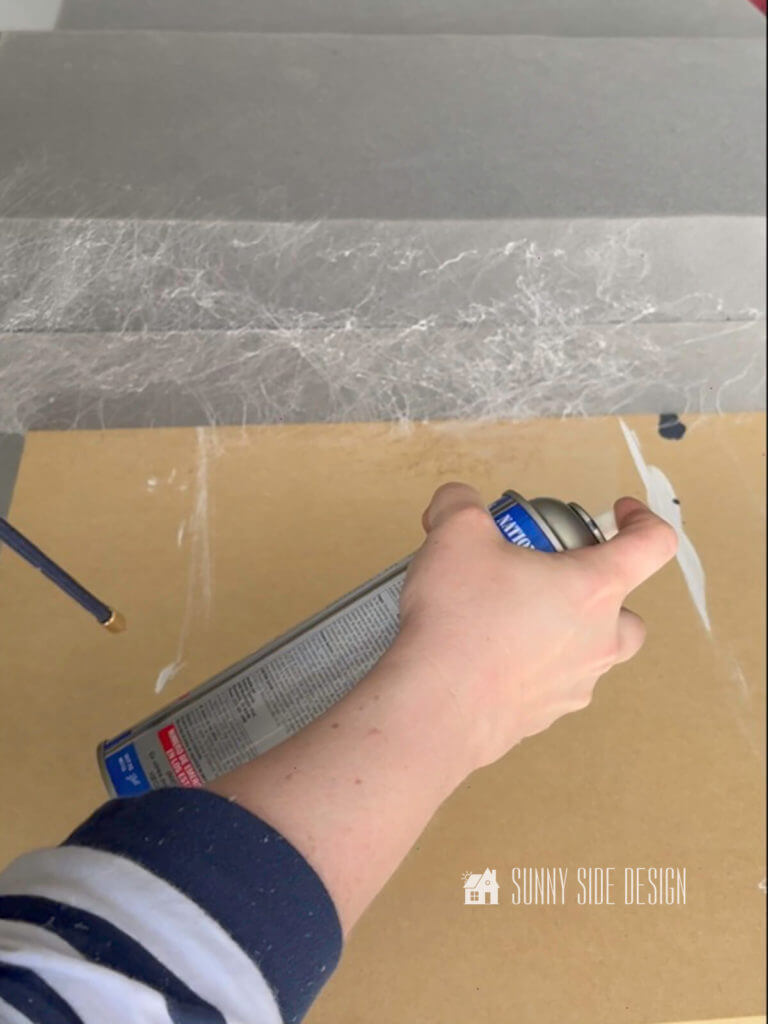 Woman with a can of foam spray glue, spraying glue on the end of the pieces of foam.