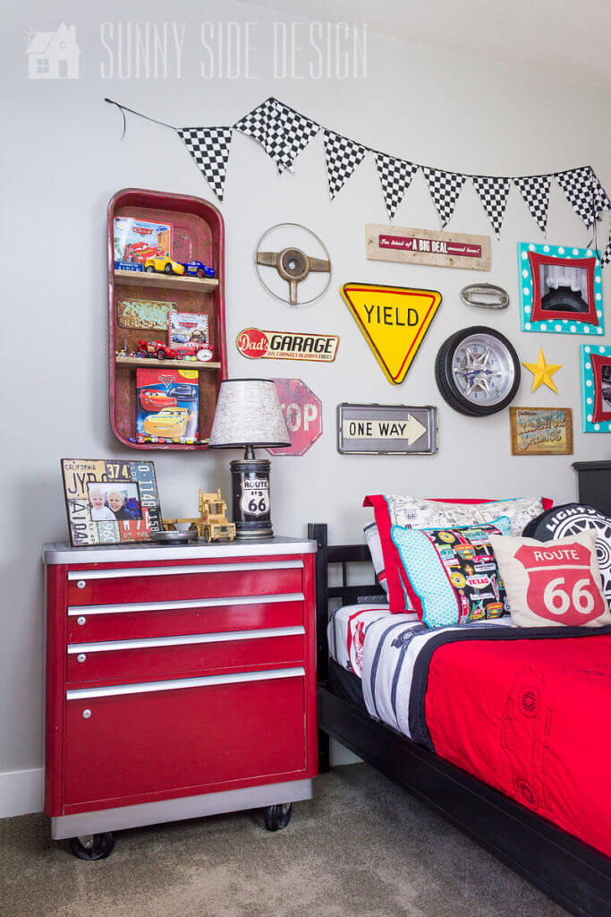 Painting furniture: Vintage lateral filing cabinet is painted glossy red with silver accents for this tool chest dresser in a boys bedroom, gallery wall above bed with traffic signs, and car parts.