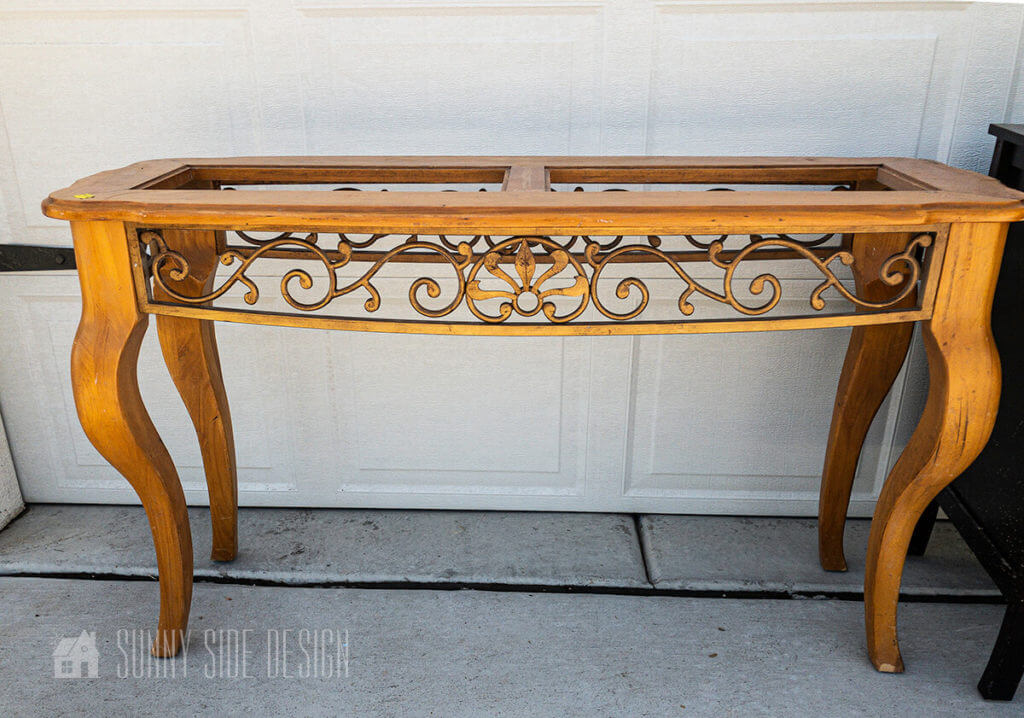 Thrift store wood and metal sofa table before it's upcycled into a bed crown canopy.